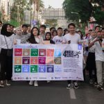 Young adults participating in a march to promote awareness of the UN Sustainable Development Goals.