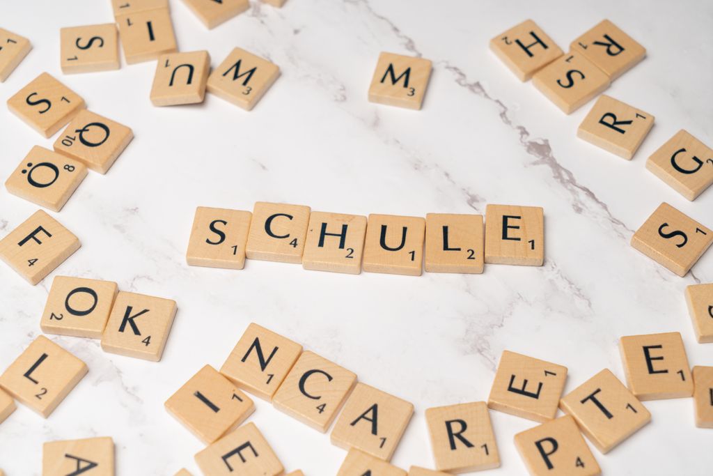 Photo by Markus Winkler Scrabble letter tiles spelling 'Schule' on a marble surface, ideal for language learning concepts.