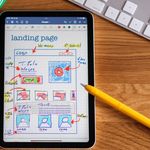 Close-up of tablet showing a hand-drawn landing page design, ideal for web development concepts.